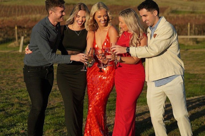 A group of people holding a bottle. 3