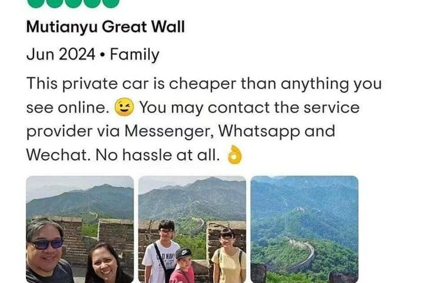 A family at the Mutianyu Great Wall, with a view of the wall and surrounding mountains. 3