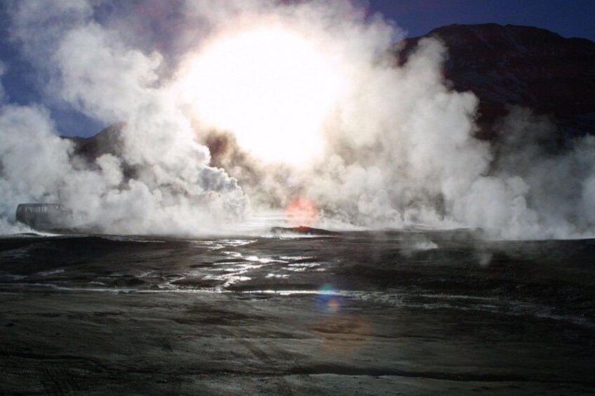 A steam vent with a mountain in the background. 5