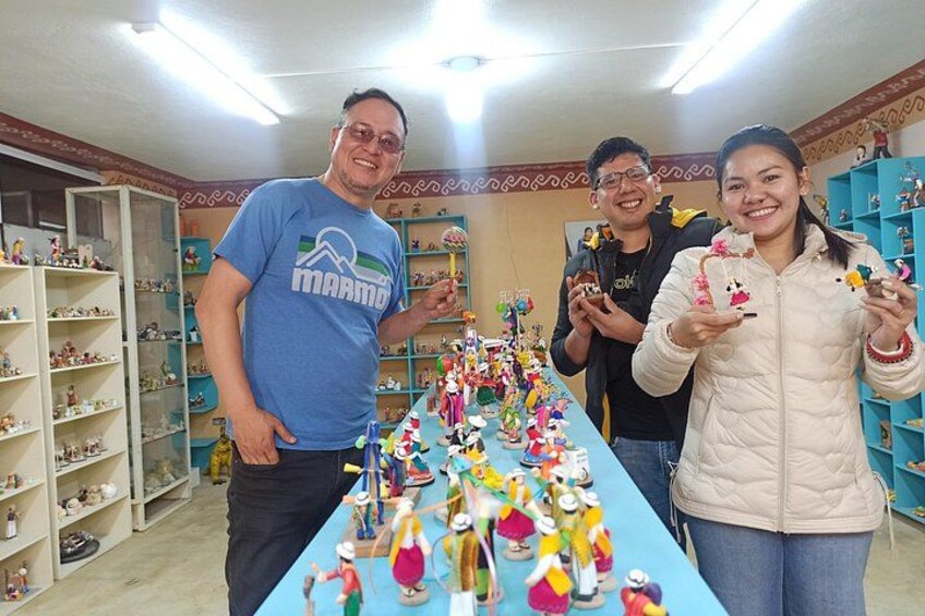 A room with shelves filled with figurines and a table with colorful toys. 1