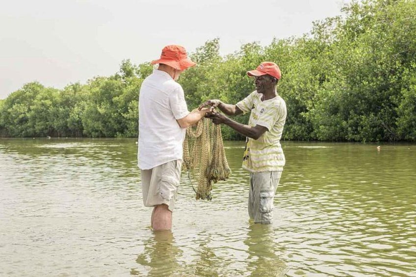 Two people standing in a river, holding nets. 2