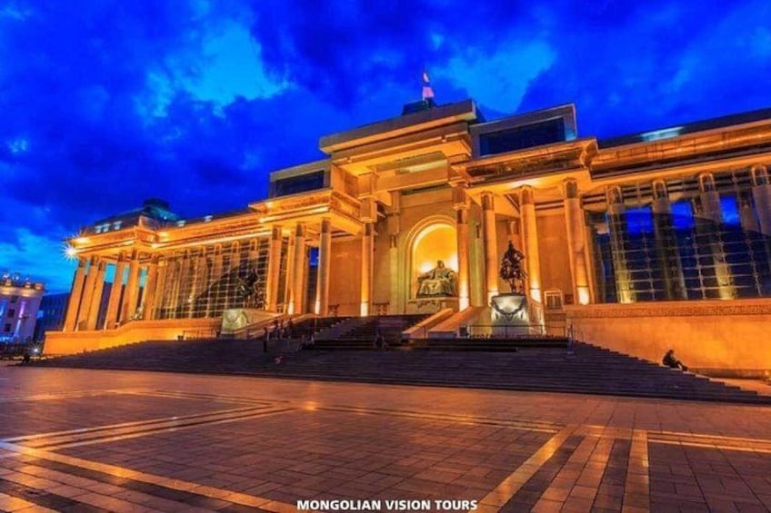A grand building with classical architecture, large columns, and a statue in front. 2