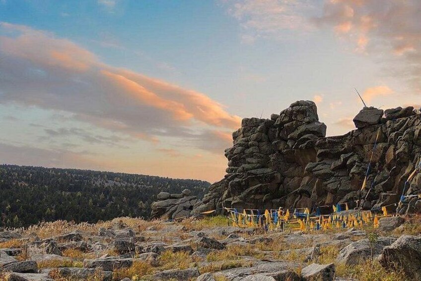 A rocky landscape with a large rock formation and a clear sky. 1