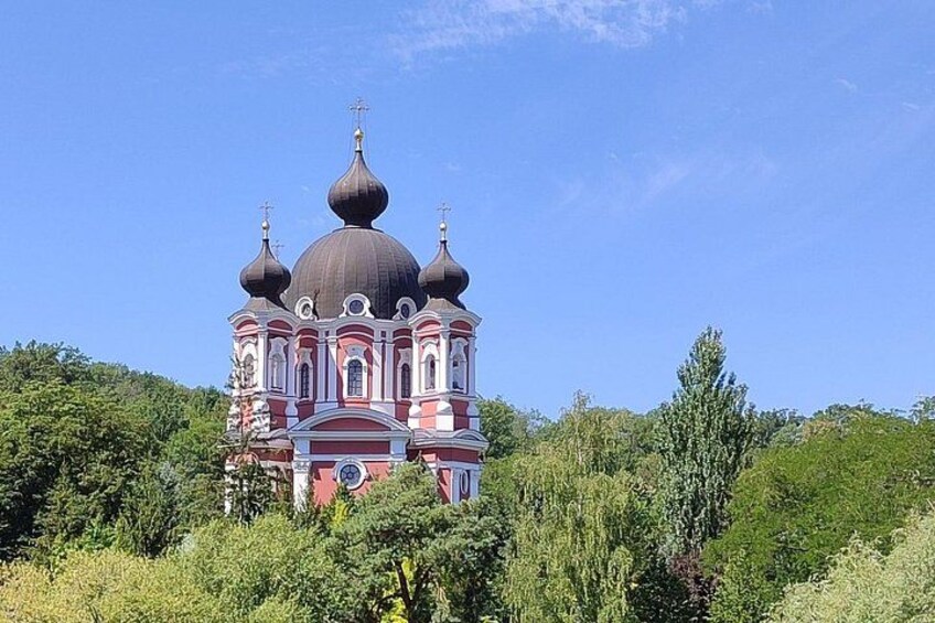 A church with multiple domes, surrounded by greenery. 2