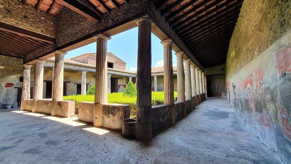 An ancient Roman structure with columns and a courtyard. 2