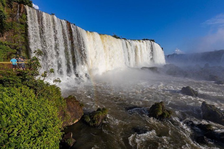 A large waterfall with multiple streams, surrounded by lush greenery and rocky terrain. 2