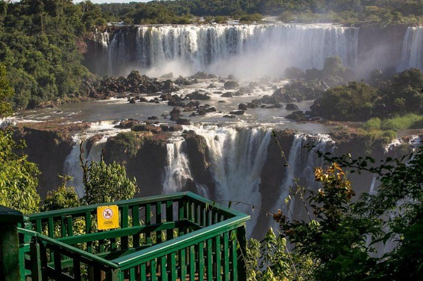 A multi-tiered waterfall with lush greenery and a viewing platform. 4