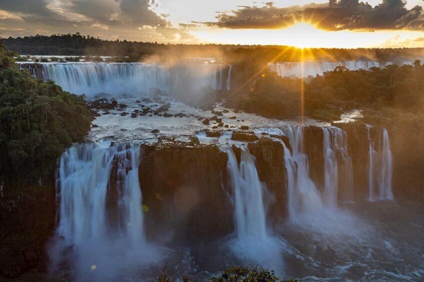 A multi-tiered waterfall with sunlight reflecting off the water. 3