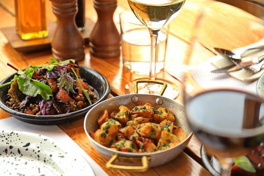 A table with dishes, a glass of wine, and a martini glass. 4