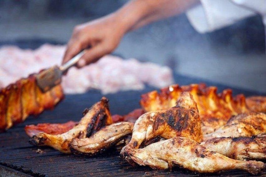 Grilled chicken skewers on a grill. 4
