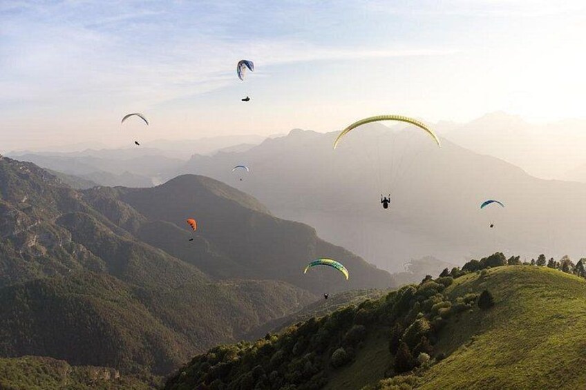 Paragliders flying over a mountainous landscape. 5