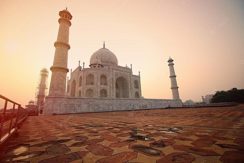 The Taj Mahal with its four minarets and a patterned walkway. 2