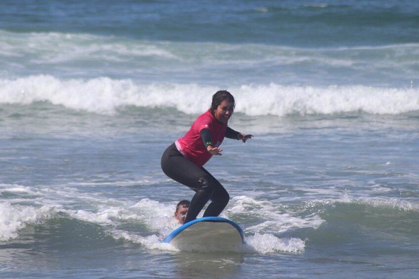 A person surfing on a wave with a blue surfboard. 2