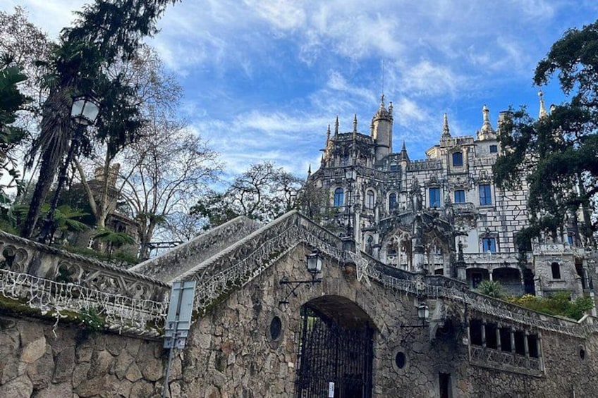 A historic castle with a stone bridge and ornate architecture. 1