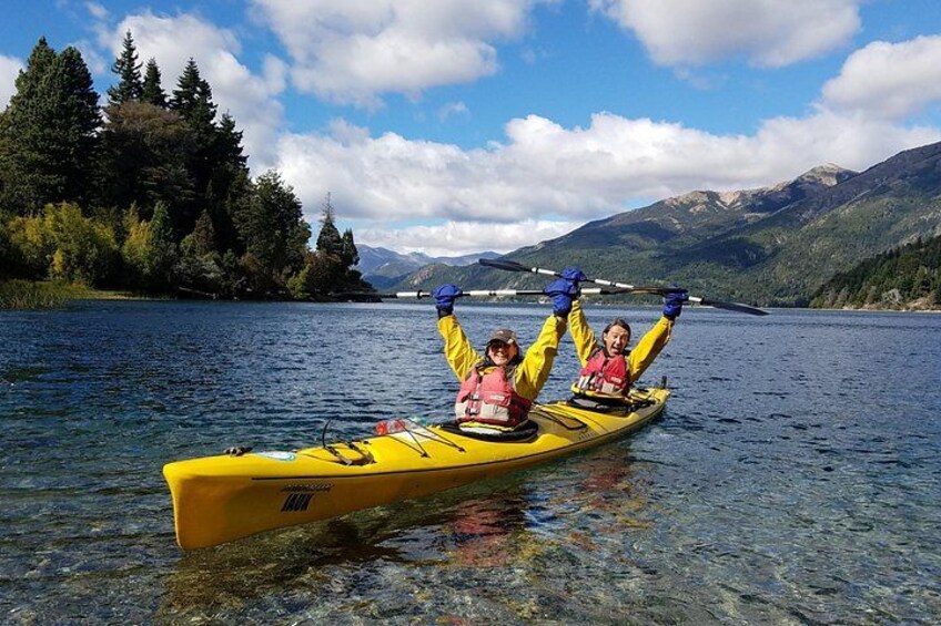 A yellow kayak on a calm lake with mountains in the background. 5