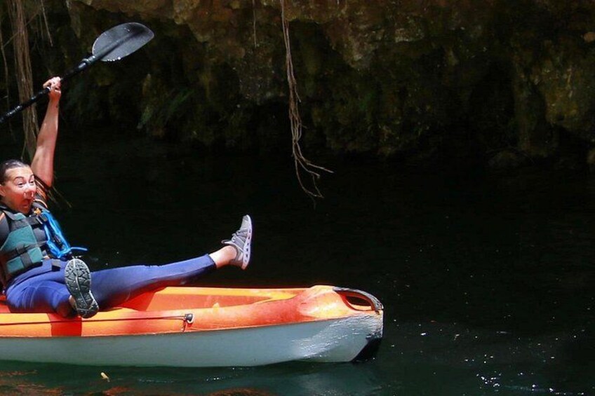 A person kayaking on a river. 5