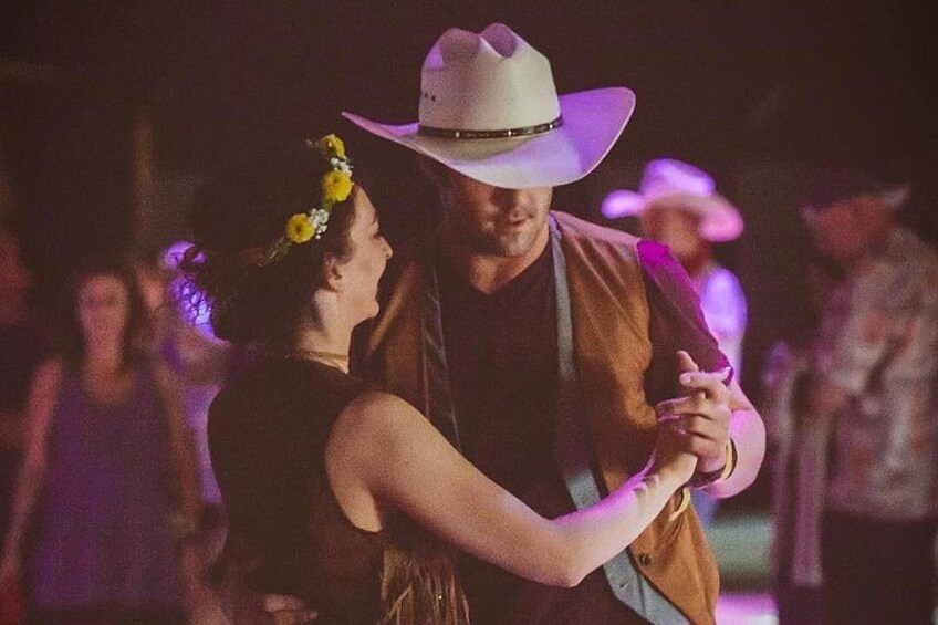A couple dancing, a man in a cowboy hat, and a woman with a flower crown. 2