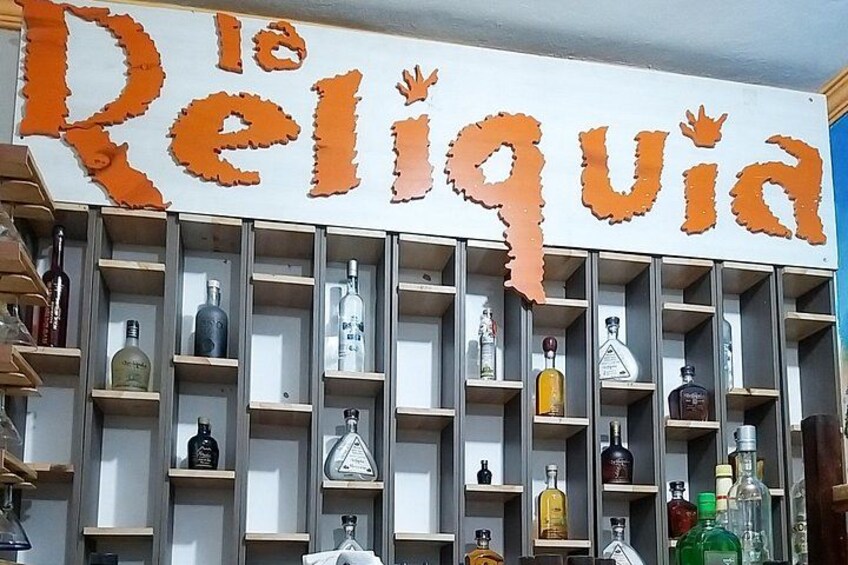 A liquor store named 'La Religieuse' with shelves of various bottles. 2