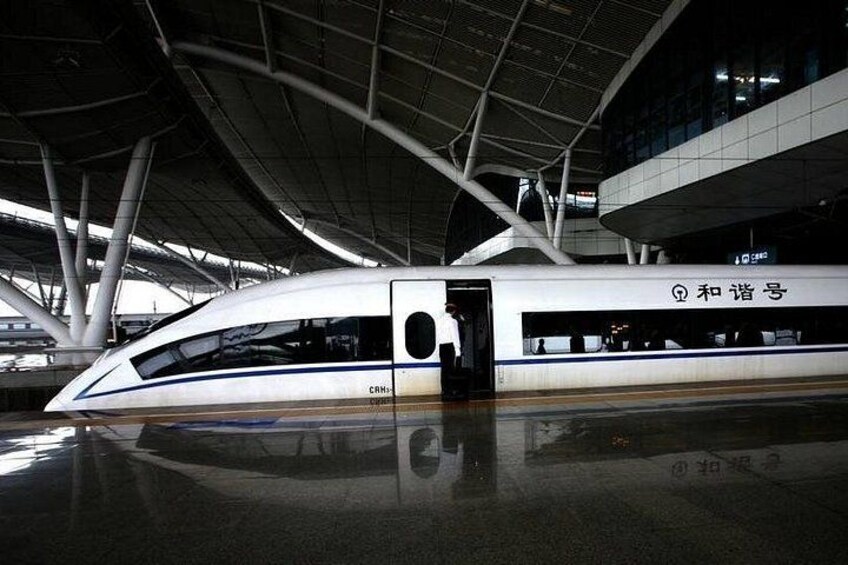 A modern train with a sleek design, a prominent door, and a reflective surface. 2
