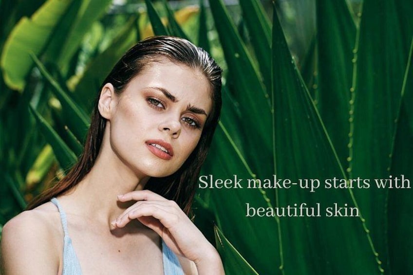 A person with a hand on their face, surrounded by green foliage. 2