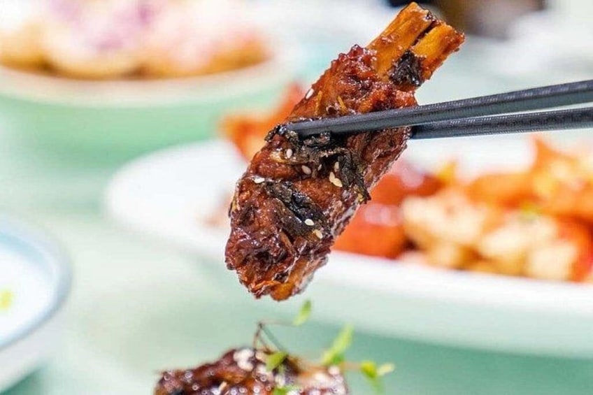 A close-up of a food item being held by chopsticks. 2