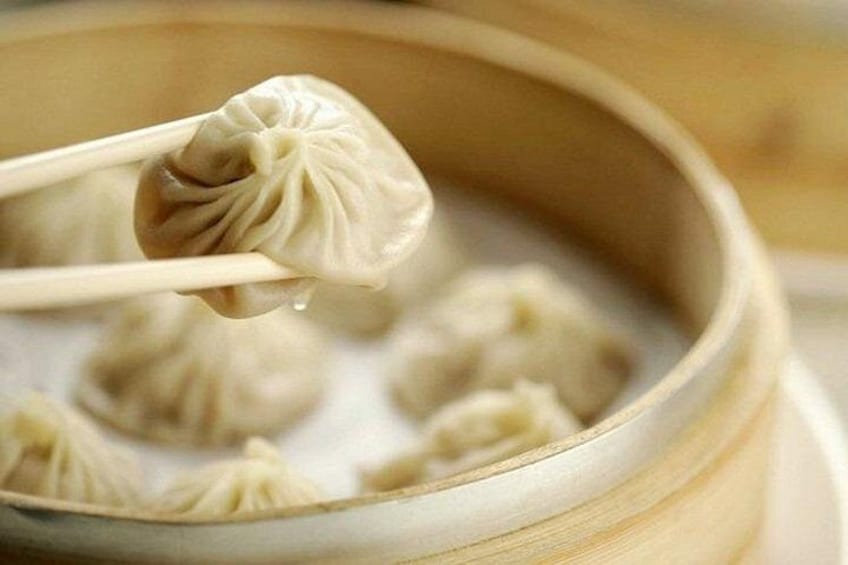 A bamboo steamer with dumplings. 3