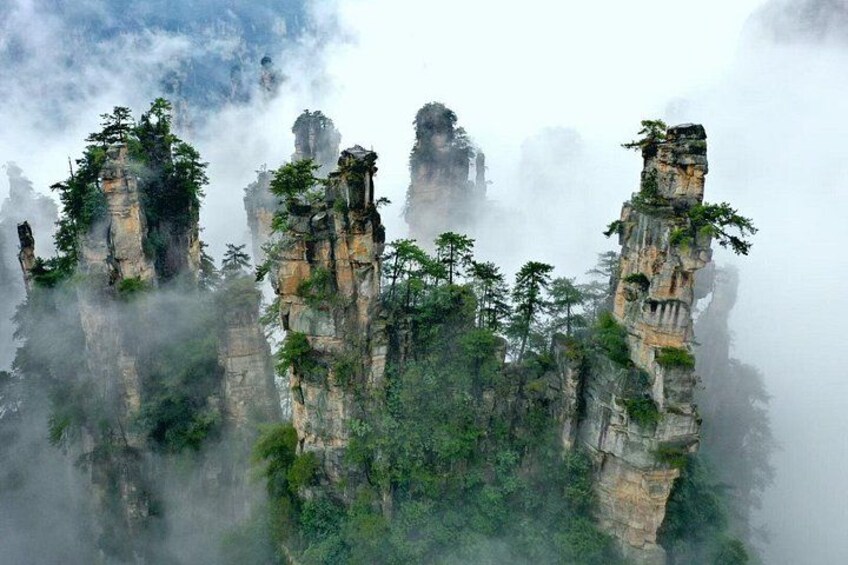 Towering rock formations with dense forest vegetation. 2