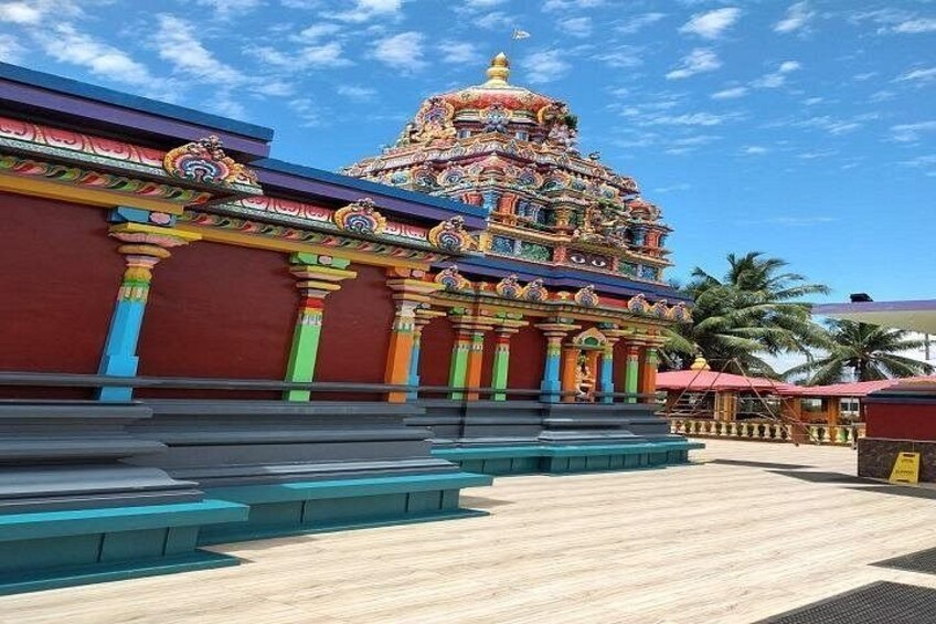 A colorful temple with intricate architecture and steps leading up to it. 2