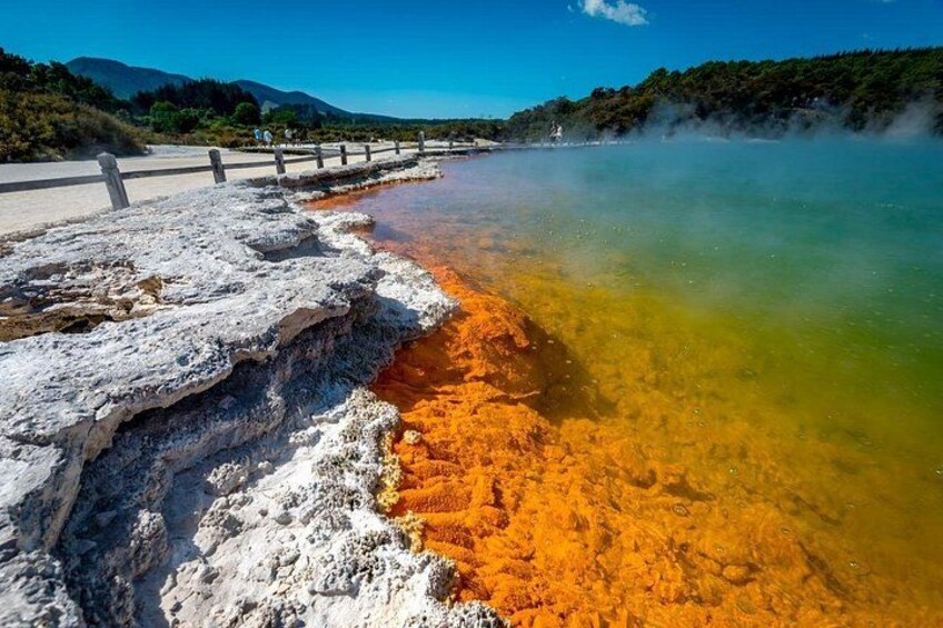 A geothermal area with mineral deposits and a clear water body. 1