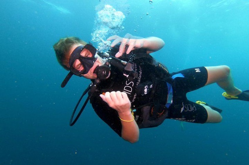 A person scuba diving underwater. 3