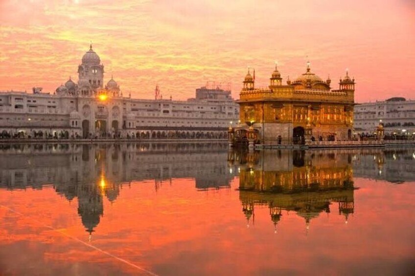 A historic building with domes and a reflection in the water. 1
