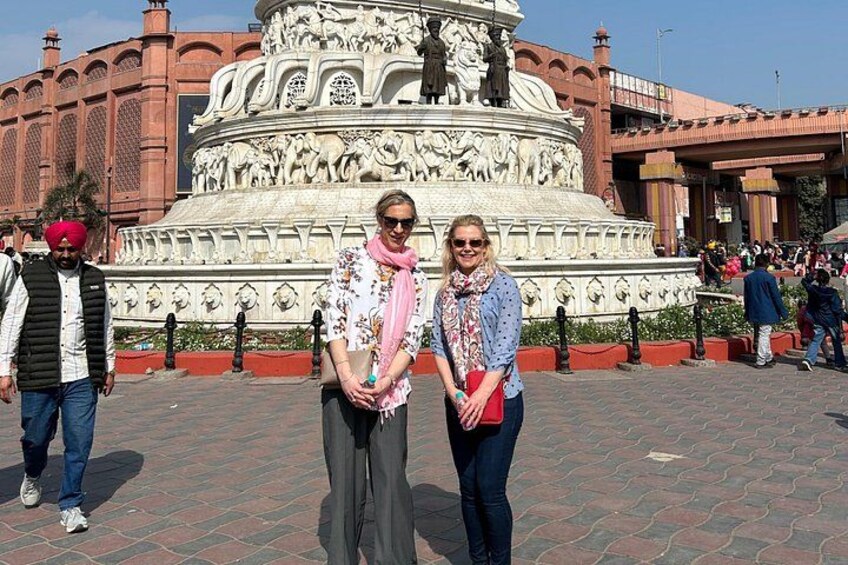 A historical monument with intricate carvings and a fountain. 3
