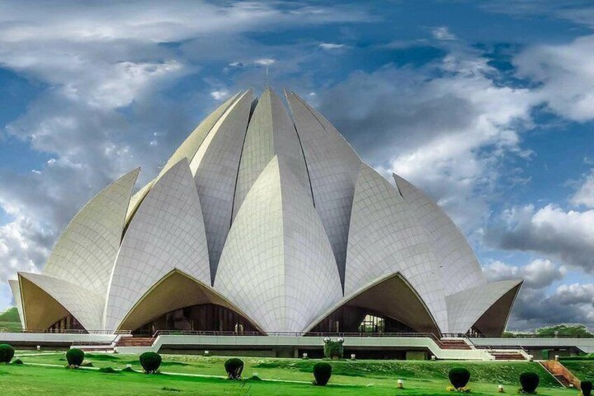 A large, white lotus-shaped building with a central dome and multiple tiers. 1