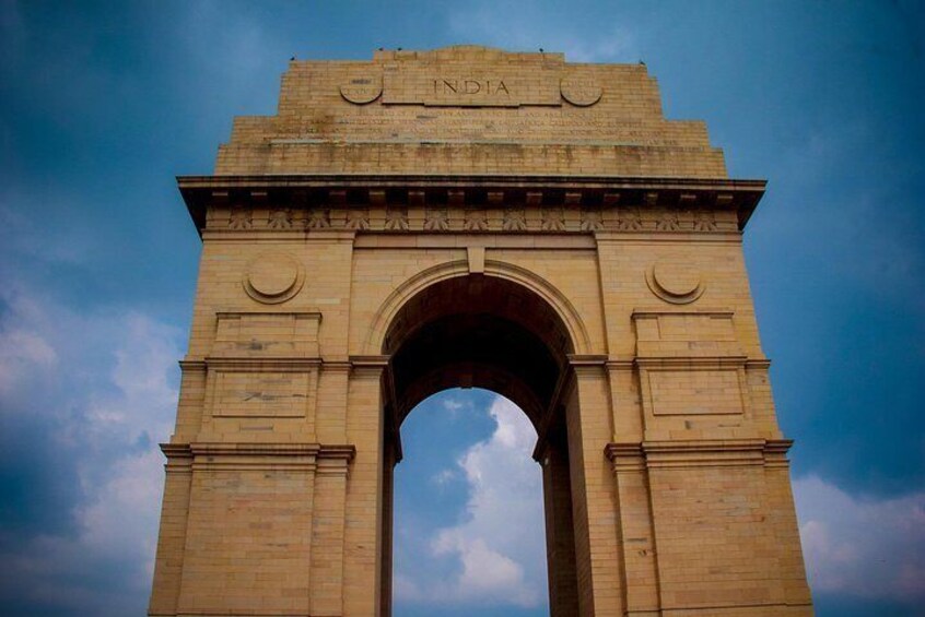 The India Gate, a large stone archway with inscriptions and decorative elements. 2