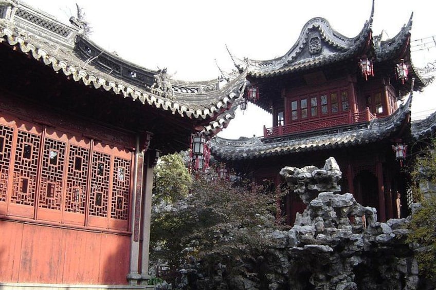 Traditional Chinese architecture with ornate roofs and red wooden structures. 2
