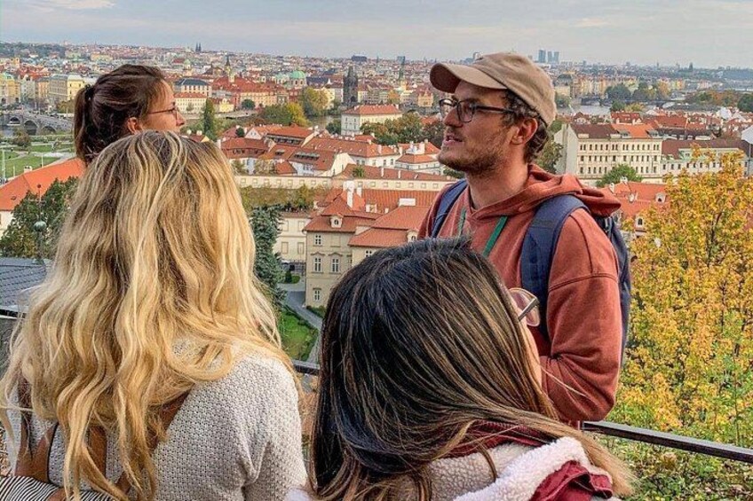 A group of people overlooking a cityscape with red-roofed buildings. 3