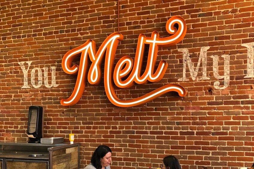 A brick wall with a neon sign that reads 'You Melt My Heart.' 5