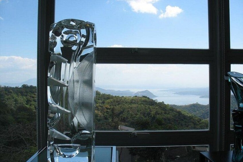 A clear glass window with a view of a mountainous landscape and a body of water. 2