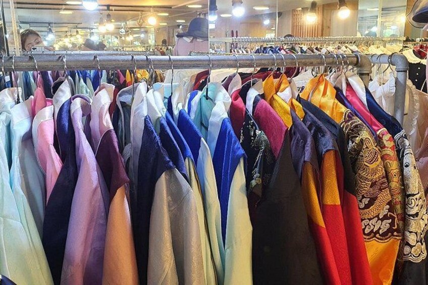 A clothing rack with various garments. 3