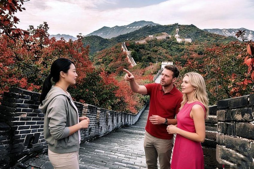 A group of people taking a selfie on a historic stone bridge with autumn foliage and a mountain in the background. 1