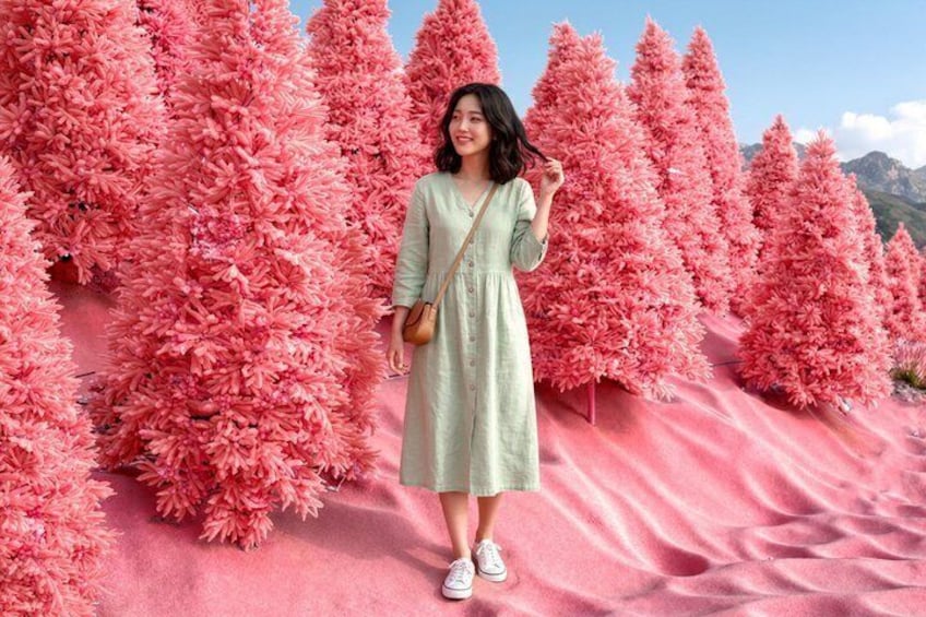 A person standing in front of pink artificial trees. 2