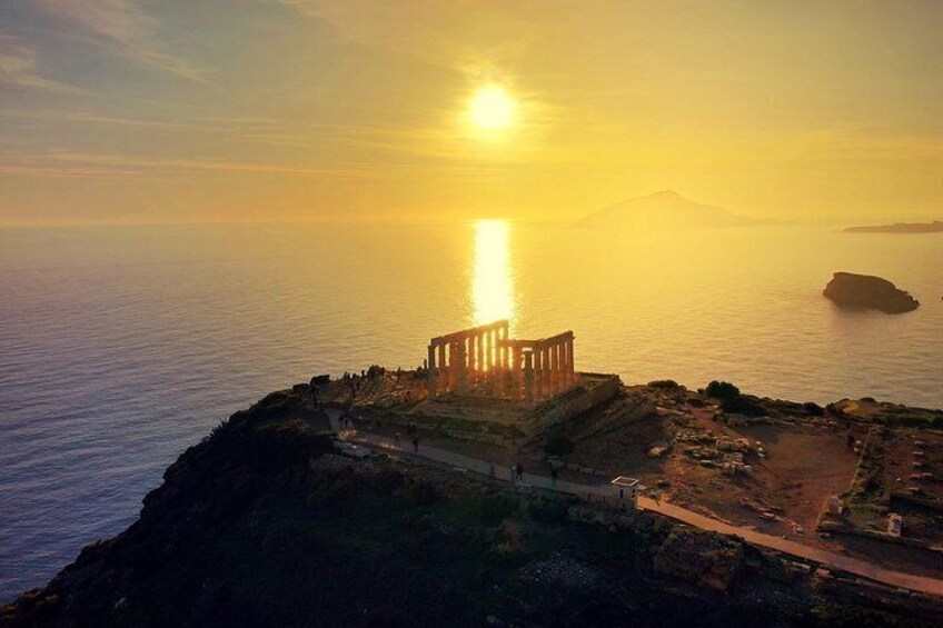 A coastal sunset with a historical structure on a cliff overlooking the sea. 1