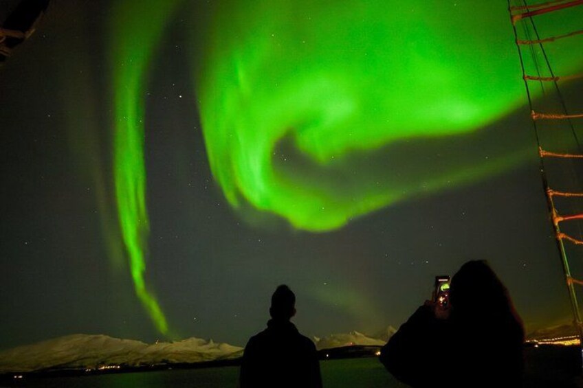 A person taking a photo of the Northern Lights. 3