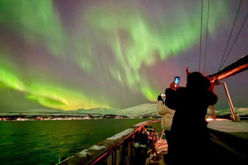 A person taking a photo of the Northern Lights. 4