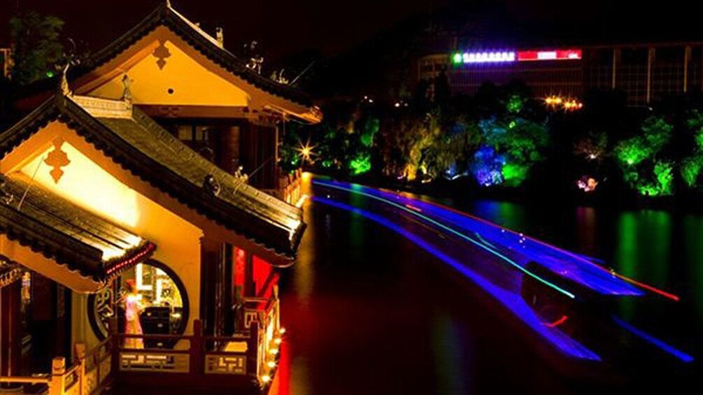 boat passing a structure along the river in Guilin