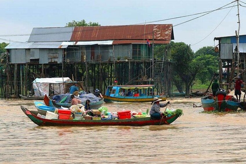 A river with boats, people, and wooden structures. 2