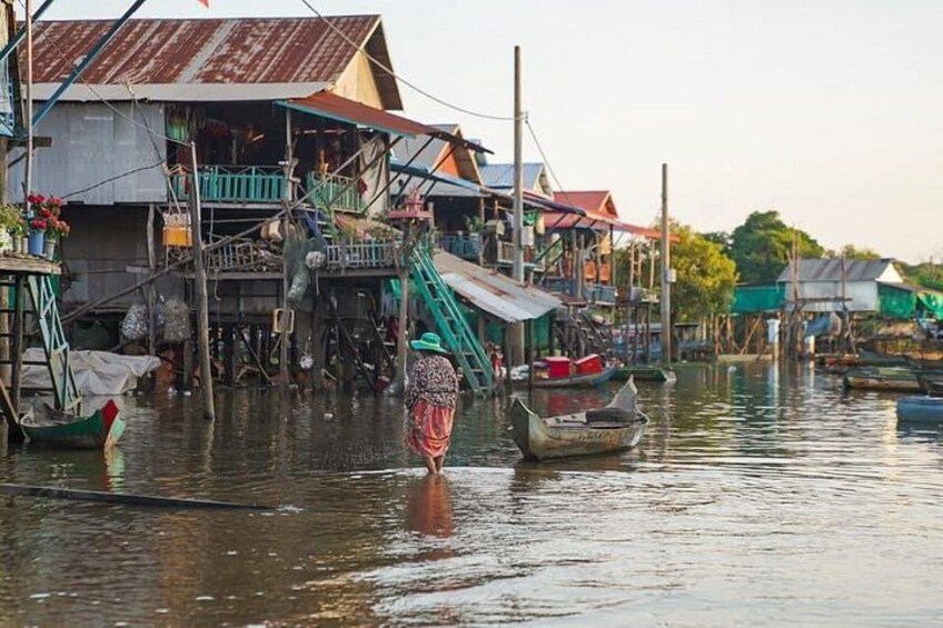 A floating village with wooden houses and boats. 4
