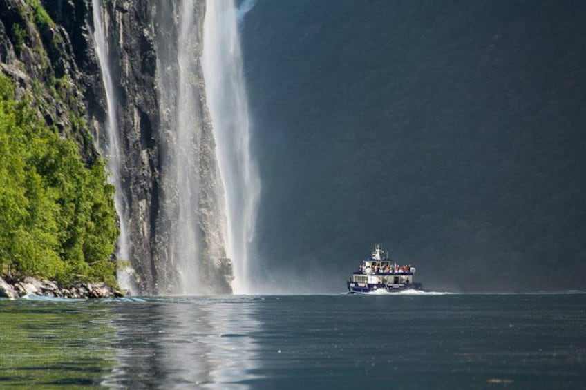 A boat near a large waterfall. 3