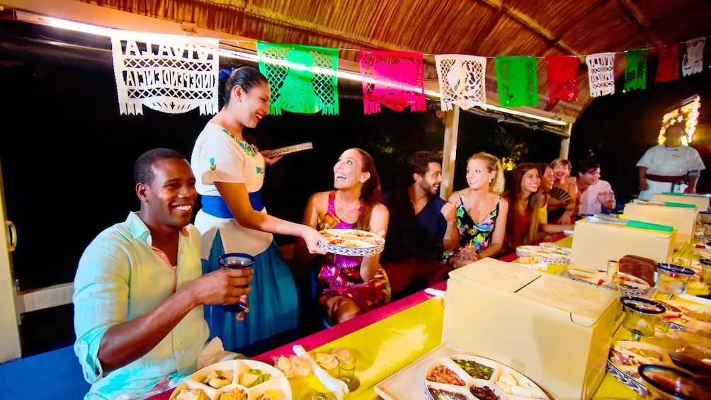 Waitress serves a table on a Mexican party boat 1