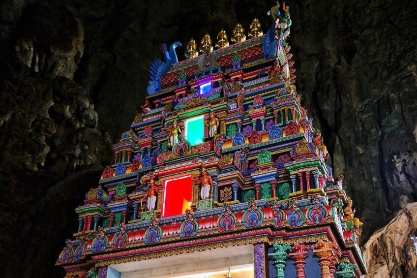 A brightly lit temple with intricate colorful carvings and statues. 3